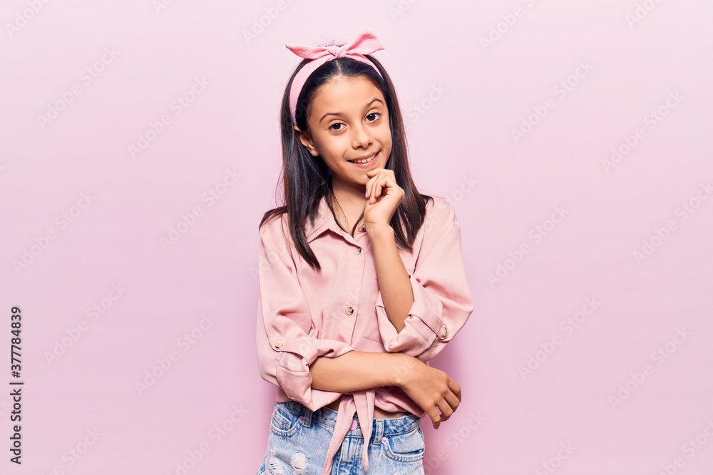 Beautiful child girl wearing casual clothes looking confident at the camera smiling with crossed arms and hand raised on chin. thinking positive. Beautiful child girl wearing casual clothes looking confident at the camera smiling with crossed arms and hand raised on chin. thinking positive.