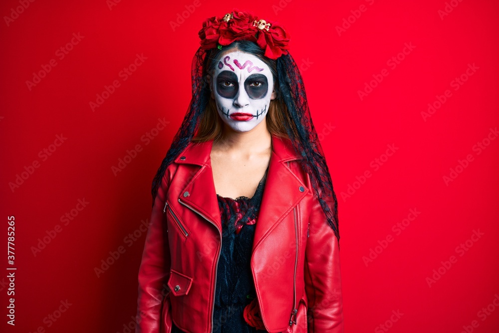 Woman wearing day of the dead costume over red skeptic and nervous, frowning upset because of problem. negative person. Woman wearing day of the dead costume over red skeptic and nervous, frowning upset because of problem. negative person.