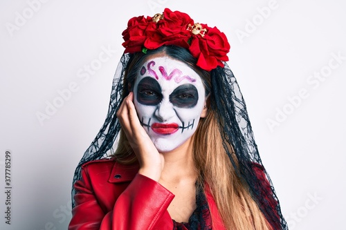 Woman wearing day of the dead costume over white thinking looking tired and bored with depression problems with crossed arms.