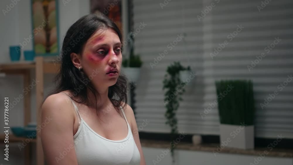 Woman suffering in the kitchen being violence victim. Violent aggressive man abusing injuring terrified helpless, vulnerable, afraid, beaten and panicked wife living in terror and pressure. Woman suffering in the kitchen being violence victim. Violent aggressive man abusing injuring terrified helpless, vulnerable, afraid, beaten and panicked wife living in terror and pressure.