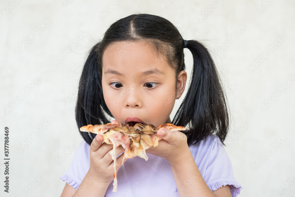 cute little girl holds piece of pizza, hungry student opens mouth wide while sees delicious slice of pizza, wants to eat, positive woman with junk food, people and eating, people and snack concept. cute little girl holds piece of pizza, hungry student opens mouth wide while sees delicious slice of pizza, wants to eat, positive woman with junk food, people and eating, people and snack concept.