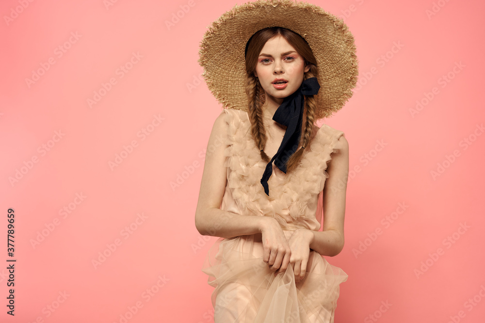 Fashionable woman in dress and hat with black ribbon on pink background cropped view of model emotions fun Fashionable woman in dress and hat with black ribbon on pink background cropped view of model emotions fun