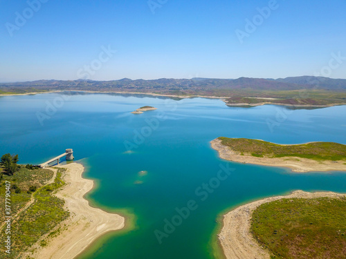 majestic aerial shot of the still blue waters and lush green hillsides at Lake Mathews in Riverside County, California photo