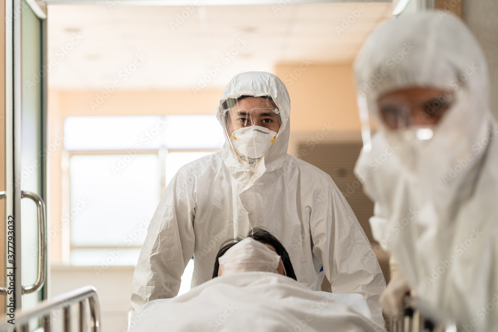 Doctor, nurse in PPE suit SWAB test Covid 19 patient in hospital
