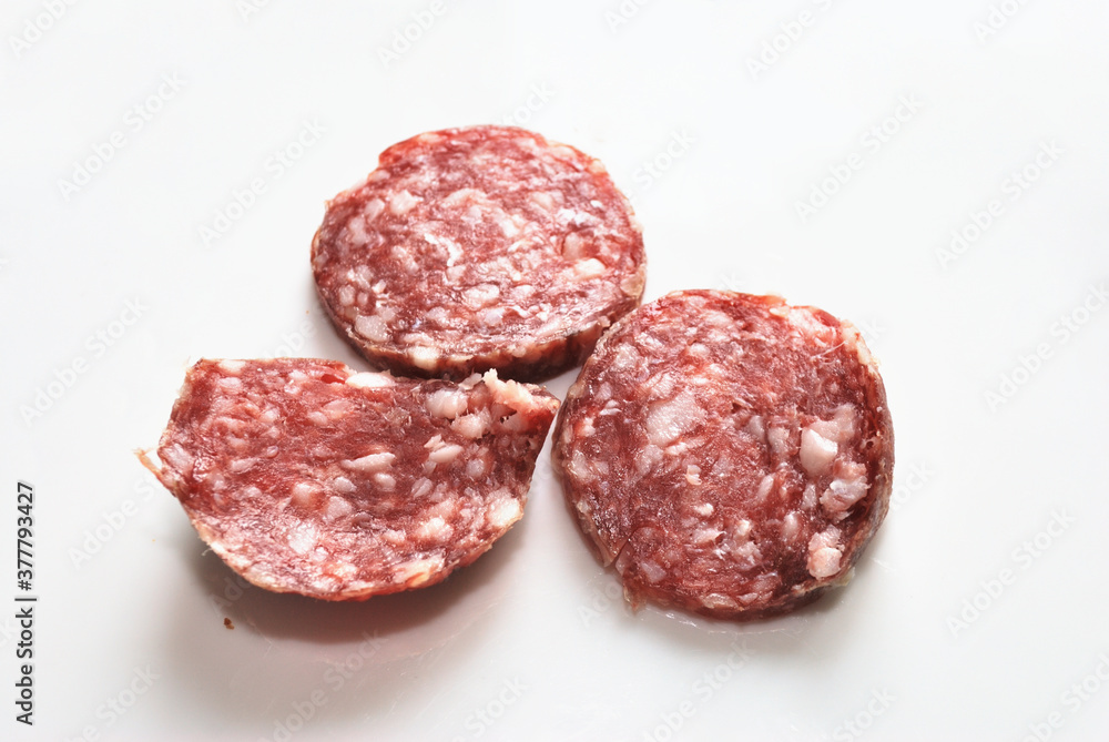 Three pieces of dry-cured sausage. Three pieces of dry-cured sausage.