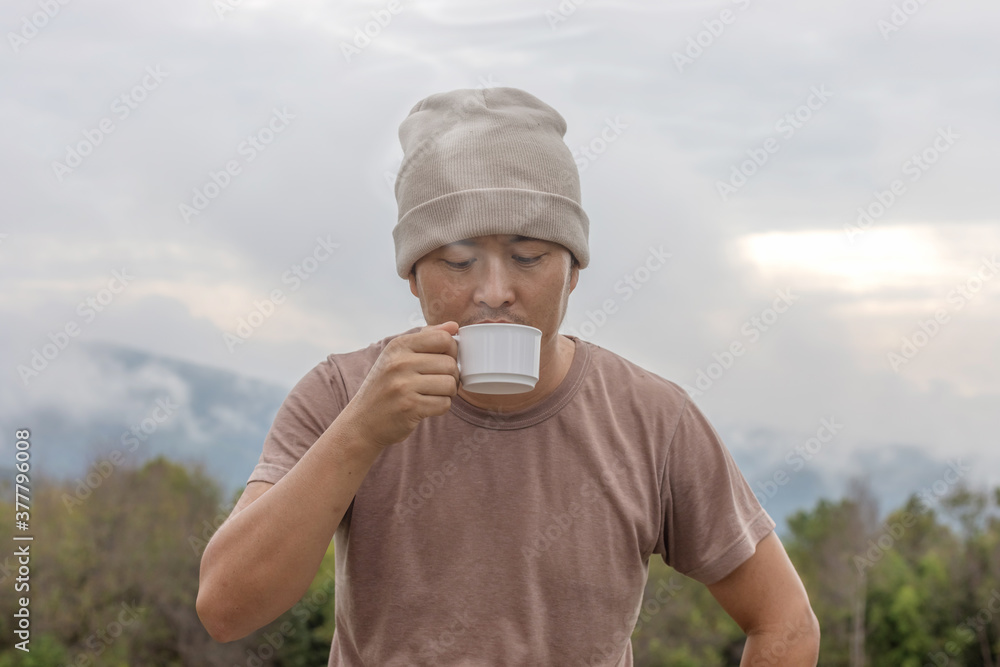 male drinking coffee with mist landscape background male drinking coffee with mist landscape background