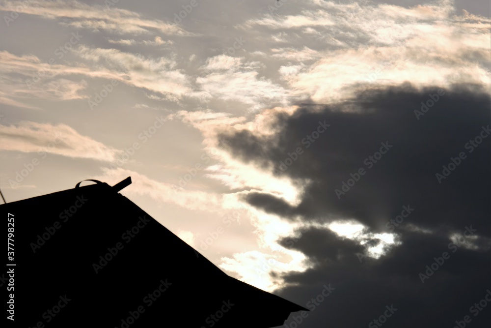 Silhouette of the house against the background of the afternoon sunset