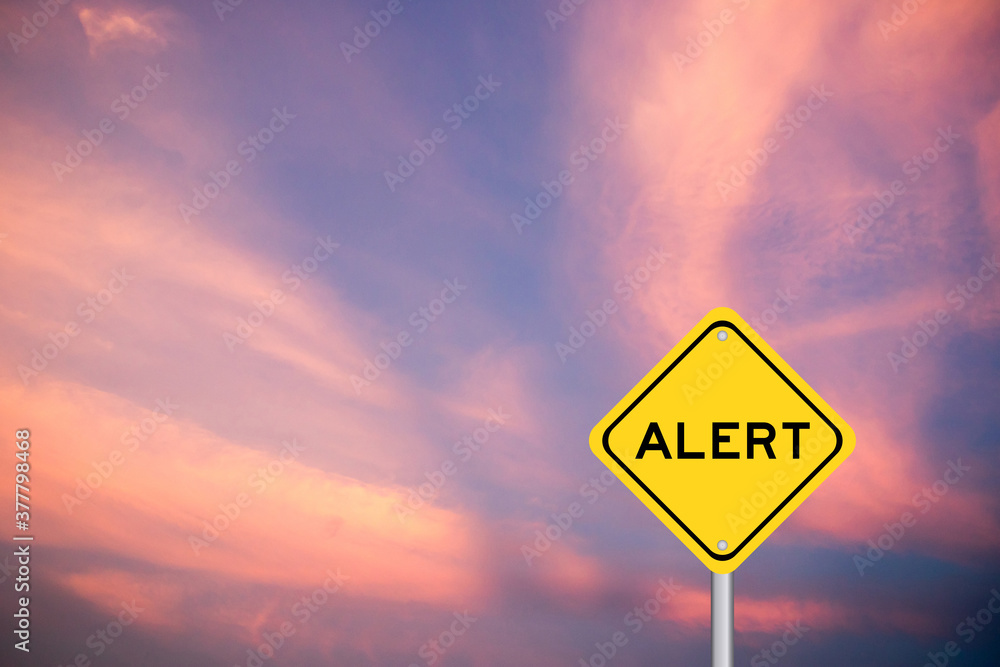 Yellow transportation sign with word alert on violet sky background Yellow transportation sign with word alert on violet sky background