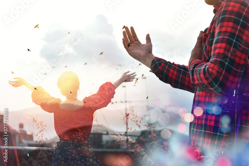 Hands folded in prayer concept for faith, spirituality and religion, Church in the city with sky background. photo