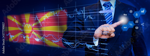 Businessman touching data analytics process system with KPI financial charts, dashboard of stock and marketing on virtual interface. With North Macedonia flag in background. © TexBr