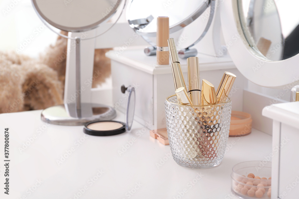 Fototapeta premium Set of decorative cosmetics on dressing table