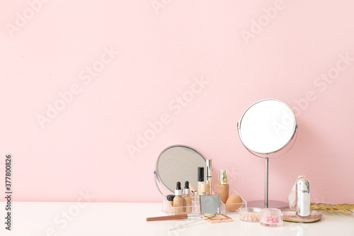 Fotografija Set of decorative cosmetics and mirrors on dressing table