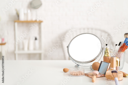 Obraz na plátne Set of decorative cosmetics and mirror on dressing table