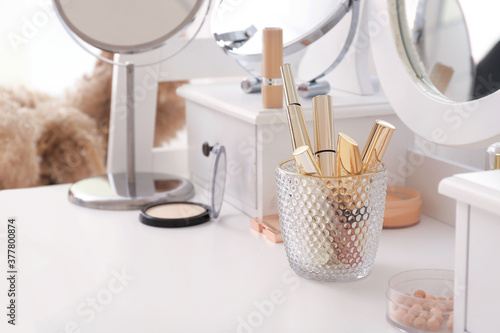 Photo Set of decorative cosmetics on dressing table
