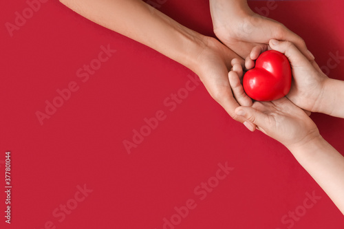 Hands Holding Red Heart on ...