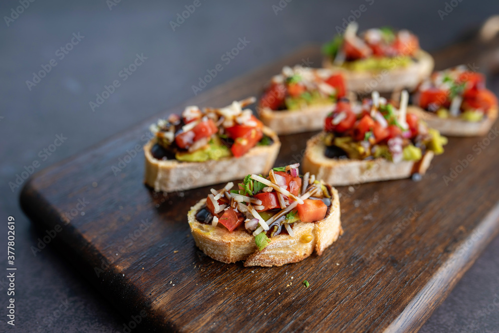 Bruschetta Sandwich served as an appetizer with tomato, avocado, onion and balsamic glaze Bruschetta Sandwich served as an appetizer with tomato, avocado, onion and balsamic glaze