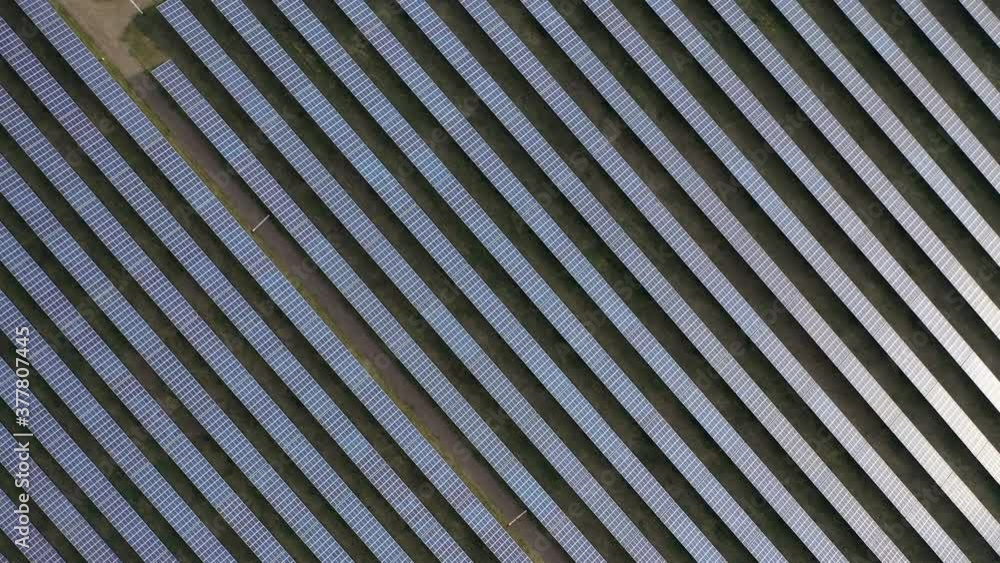 Aerial drone view into large solar panels at a solar farm. Solar cell power plants. footage video 4k. Aerial drone view into large solar panels at a solar farm. Solar cell power plants. footage video 4k.