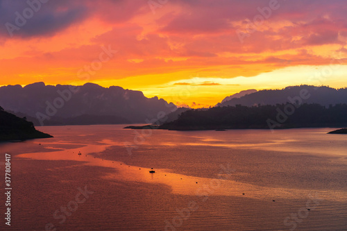 Dramatic sunset with twilight color sky and clouds from top view point of the dam. Background of colorful sky concept. Copy space © Pattarisara