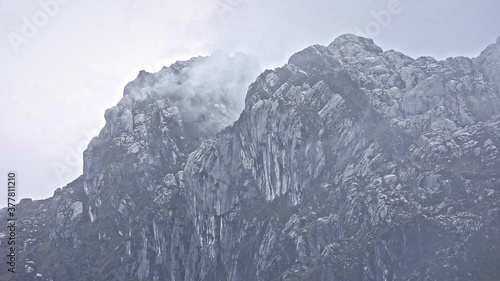 Hazy Mount Carstensz Jayawijaya in Sudirman Mountain Range, Papua, Indonesia covered by clouds HD Stock Footage Video photo