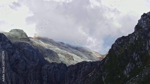 Time lapse of  Mountain Carstensz Gunung Jayawijaya, the tropical glacier in summer with moving clouds above limestones mountain photo