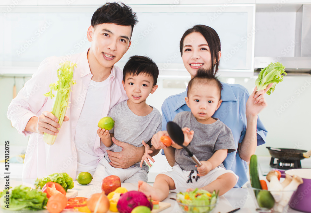 happy family showing healthy food in kitchen happy family showing healthy food in kitchen