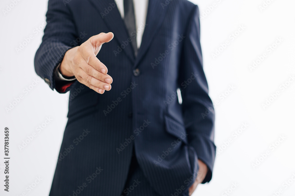 Cropped image of entrepreneur outstretching hand for handshake when greeting colleague Cropped image of entrepreneur outstretching hand for handshake when greeting colleague