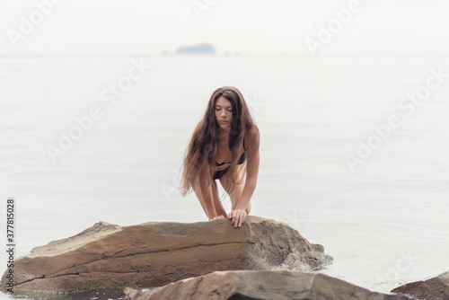 Portrait of young woman on the sea background. Outdoors.