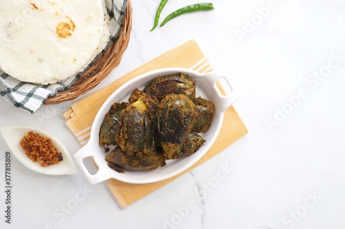 Indian, Maharashtrian side dish or appetizer Bharli Vangi, stuffed Eggplants, Crispy brinjal fry, Aubergine stuffed, served with Rice flour bhakri. copy space