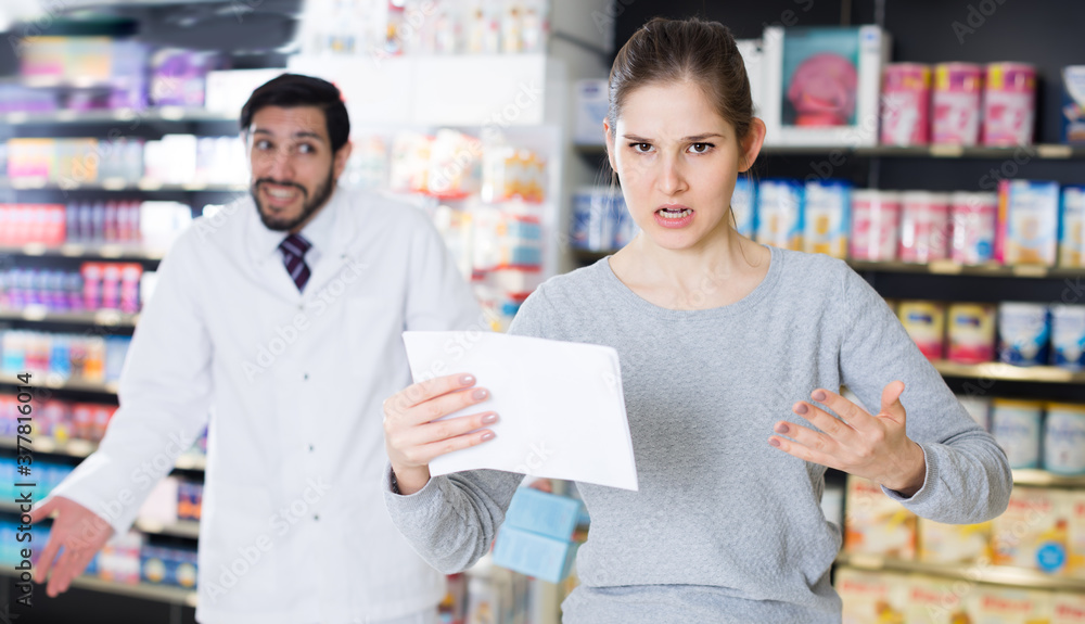 Angry female is dissatisfied of recommended medicine in apothecary