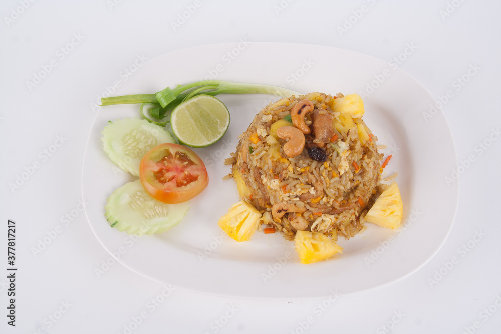Fried rice with seafood served in a pineapple isolated on white background