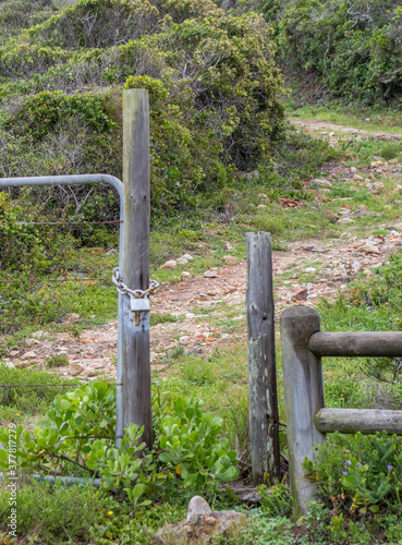 A securely locked gate but there is no fence image in vertical format