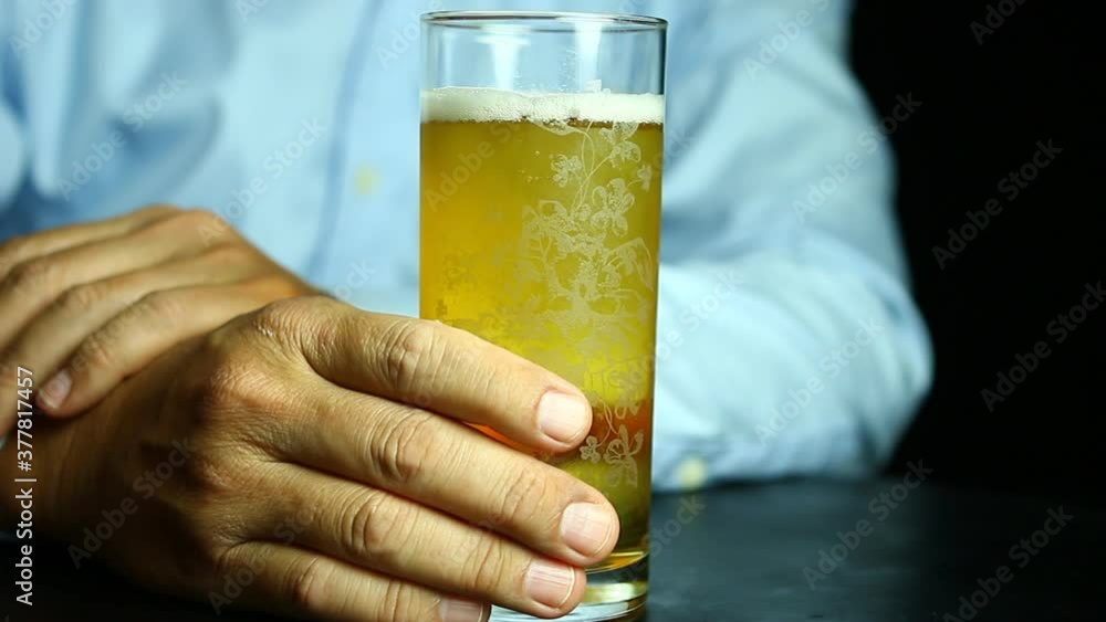 Man holding a glass of beer , in studio Chiangmai Thailand Man holding a glass of beer , in studio Chiangmai Thailand