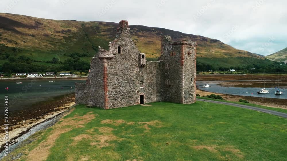 Ancient castle ruins aerial shot on Loch Ranza bay. Historical monument and heritage of British culture. Amazing scenery on Arran Island, Scotland, UK, Europe. Footage view Ancient castle ruins aerial shot on Loch Ranza bay. Historical monument and heritage of British culture. Amazing scenery on Arran Island, Scotland, UK, Europe. Footage view