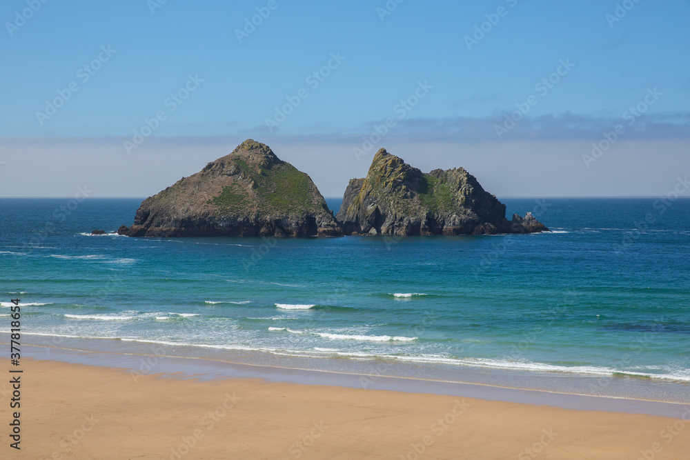 Holywell Bay Cornwall with rocks waves beach and coast on a beautiful day Holywell Bay Cornwall with rocks waves beach and coast on a beautiful day