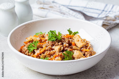 Φωτογραφία Buckwheat with chicken meat and vegetables in a white plate, white background