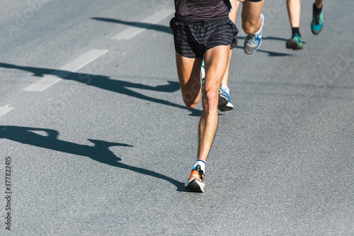 Marathon running race. Close up of the many runners feet on road racing, sport competition, fitness and healthy lifestyle concept