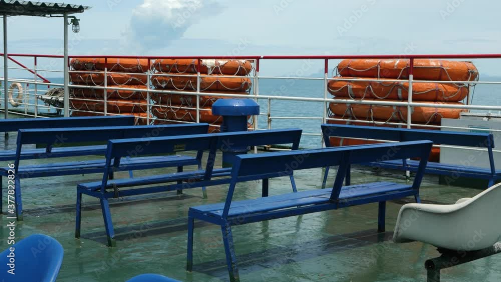Seats for passengers on ferry ship. Small rigid lifeboat or life raft