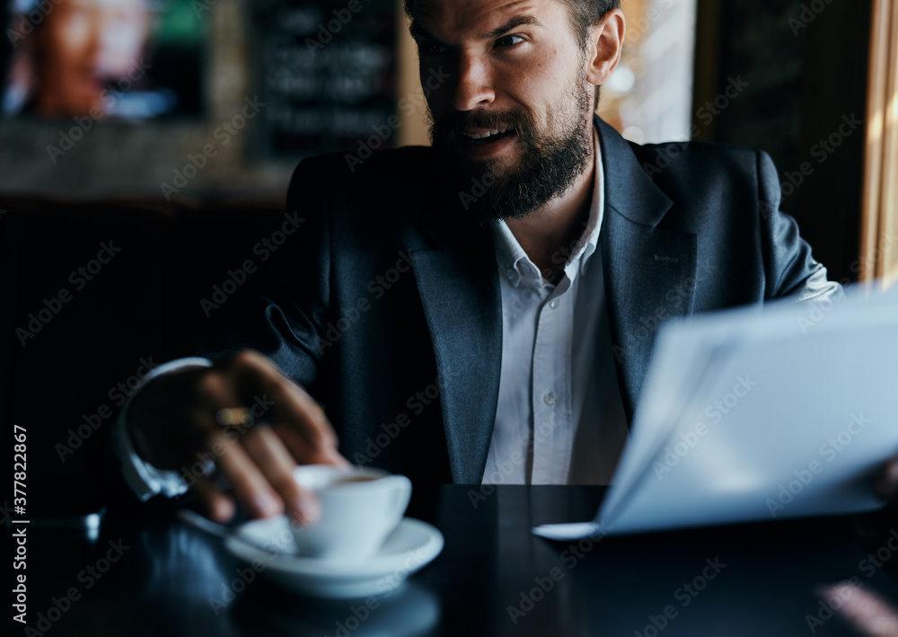 business man sitting at a table in a cafe documents work official coffee cup business man sitting at a table in a cafe documents work official coffee cup