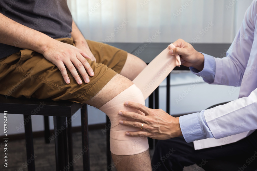 Asian physiotherapists are examining the results of knee surgery.