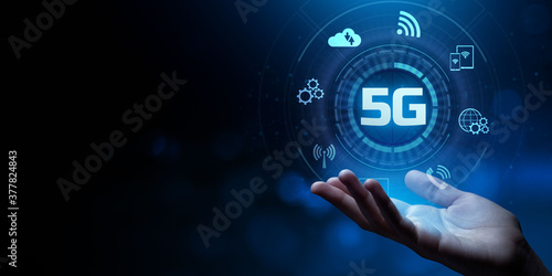 5G mobile internet connection five generation networking concept. Businessman pointing virtual screen.