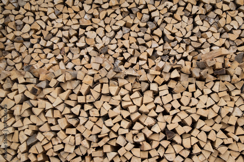 Composition pile of wood logs for background. Natural wooden logs stacked Stocking up for winter. A pile of cut tree brown trunks Composition pile of wood logs for background. Natural wooden logs stacked Stocking up for winter. A pile of cut tree brown trunks