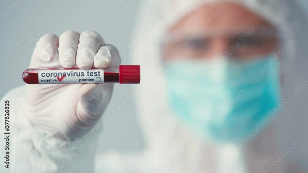 selective focus of scientist in latex glove holding test tube isolated on grey selective focus of scientist in latex glove holding test tube isolated on grey