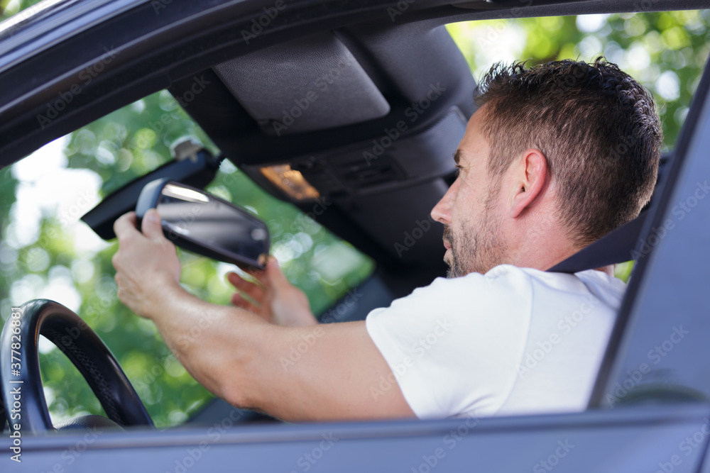 a man fixing rear mirror a man fixing rear mirror