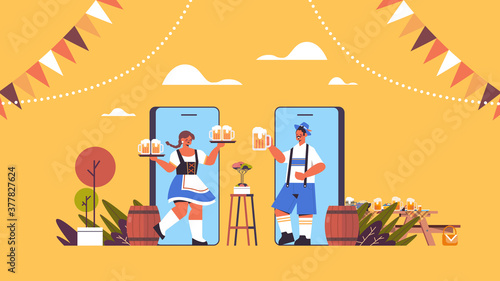 man woman on smartphone screens holding beer mugs Oktoberfest party celebration online communication self isolation concept horizontal full length vector illustration