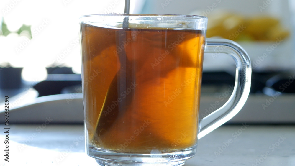 Image with Making a Hot and Aromatic Tea with Sugar and Fresh Lemon Using Natural Tea Leaves Image with Making a Hot and Aromatic Tea with Sugar and Fresh Lemon Using Natural Tea Leaves