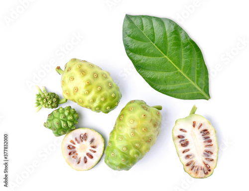 Photography Flat lay (Top view) of Noni or Morinda Citrifolia fruits with sliced and green l