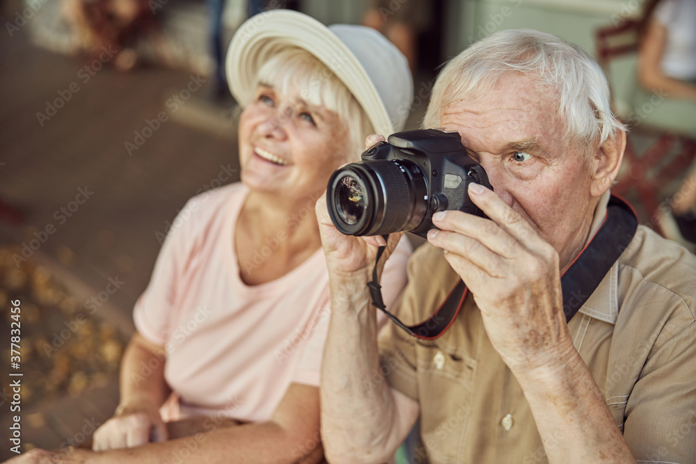 Woman and a man with an optical device Woman and a man with an optical device