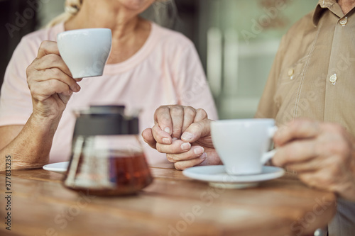 Senior couple in love sitting in a cafe