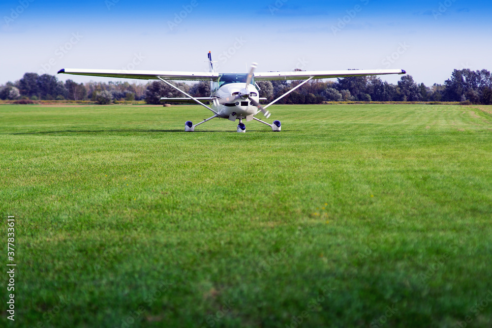 the plane is standing on a grassy airport the plane is standing on a grassy airport