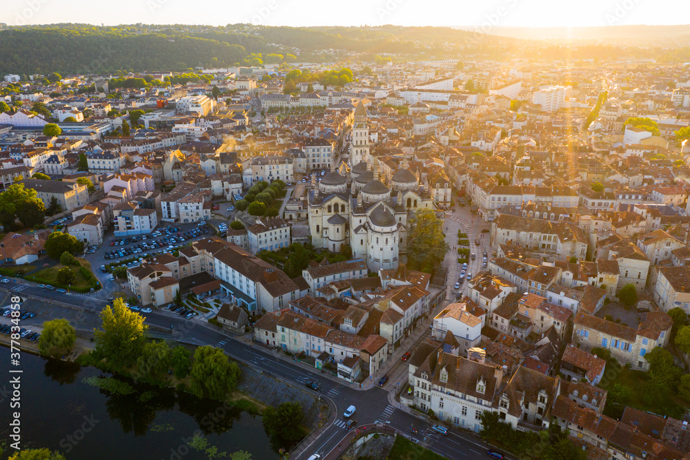 Drone view of French city of Perigueux on Isle River overlooking Romanesque building of ancient cathedral during summer sunset..